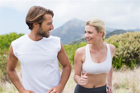 simsearch:400-08017390,k - Attractive couple jogging on mountain trail on a sunny day Photographie de stock - Aubaine LD & Abonnement, Code: 400-07724291