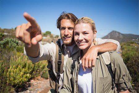 Happy hiking couple walking on mountain terrain on a sunny day Stock Photo - Budget Royalty-Free & Subscription, Code: 400-07724445