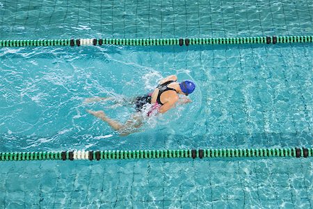 simsearch:400-07583094,k - Fit swimmer training by herself in swimming pool at the leisure centre Stock Photo - Budget Royalty-Free & Subscription, Code: 400-07724816