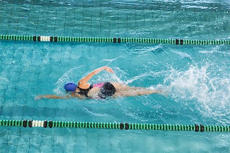 simsearch:400-07583085,k - Fit swimmer training by herself in swimming pool at the leisure centre Stock Photo - Budget Royalty-Free & Subscription, Code: 400-07724817