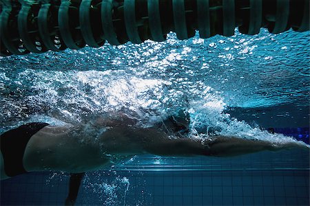 simsearch:614-06043548,k - Fit swimmer training on his own in the swimming pool at the leisure centre Photographie de stock - Aubaine LD & Abonnement, Code: 400-07724865