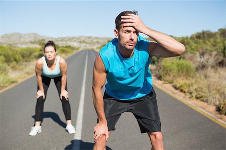 simsearch:400-08017390,k - Fit couple jogging on the open road together on a sunny day Photographie de stock - Aubaine LD & Abonnement, Code: 400-07724974