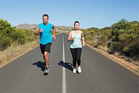 simsearch:400-07936740,k - Fit couple jogging on the open road together on a sunny day Foto de stock - Super Valor sin royalties y Suscripción, Código: 400-07724971