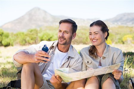 people on trail with map - Happy hiking couple reading the map on mountain trail on a sunny day Stock Photo - Budget Royalty-Free & Subscription, Code: 400-07725128