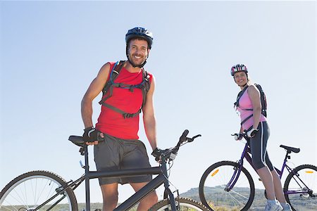 pictures of the cyclist track - Fit cyclist couple standing at the summit smiling at camera on a sunny day Stock Photo - Budget Royalty-Free & Subscription, Code: 400-07725209