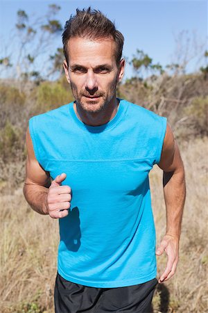 simsearch:400-08017381,k - Athletic man jogging in the countryside on a sunny day Photographie de stock - Aubaine LD & Abonnement, Code: 400-07725256