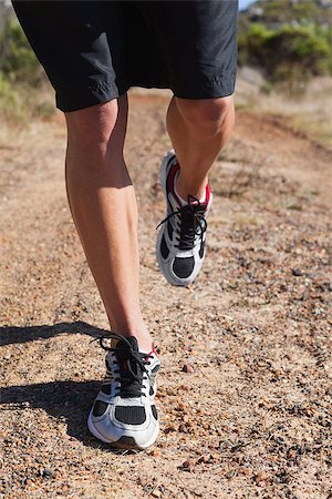 simsearch:400-07725266,k - Athletic man jogging in the countryside on a sunny day Photographie de stock - Aubaine LD & Abonnement, Code: 400-07725257