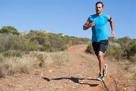 simsearch:400-07936740,k - Athletic man jogging on country trail on a sunny day Foto de stock - Super Valor sin royalties y Suscripción, Código: 400-07725264