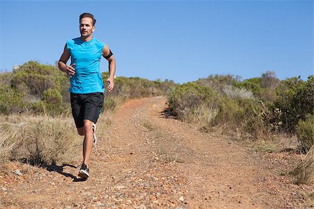 simsearch:400-08017390,k - Athletic man jogging on country trail on a sunny day Photographie de stock - Aubaine LD & Abonnement, Code: 400-07725265