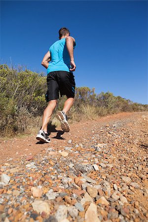 simsearch:400-07725266,k - Athletic man jogging up country trail on a sunny day Photographie de stock - Aubaine LD & Abonnement, Code: 400-07725262