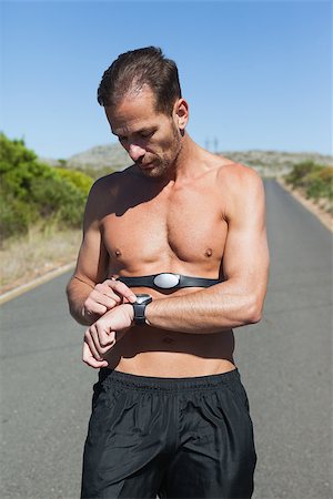 simsearch:400-07725266,k - Athletic man on open road with monitor around chest on a sunny day Photographie de stock - Aubaine LD & Abonnement, Code: 400-07725275