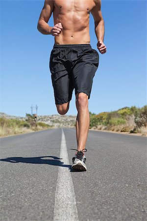 simsearch:400-08017390,k - Shirtless man jogging on open road on a sunny day Photographie de stock - Aubaine LD & Abonnement, Code: 400-07725281