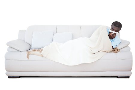 simsearch:400-06888942,k - Sick man lying on couch blowing his nose on white background Photographie de stock - Aubaine LD & Abonnement, Code: 400-07725441