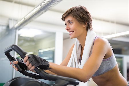 simsearch:400-07725772,k - Fit smiling woman working out on the exercise bike at the gym Photographie de stock - Aubaine LD & Abonnement, Code: 400-07725694