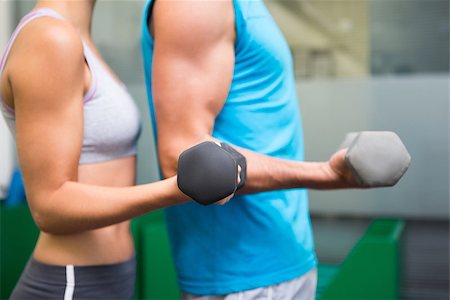 simsearch:400-07725931,k - Fit couple lifting dumbbells together at the gym Photographie de stock - Aubaine LD & Abonnement, Code: 400-07725698