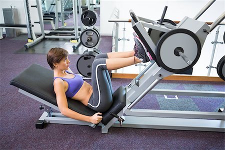 simsearch:400-07725772,k - Fit brunette using weights machine for legs at the gym Photographie de stock - Aubaine LD & Abonnement, Code: 400-07725776