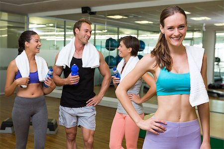 simsearch:400-07725931,k - Fit woman smiling at camera in busy fitness studio at the gym Photographie de stock - Aubaine LD & Abonnement, Code: 400-07725902