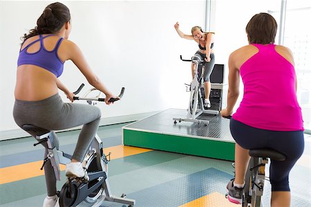 simsearch:400-07725772,k - Spin class working out with motivational instructor at the gym Photographie de stock - Aubaine LD & Abonnement, Code: 400-07725914