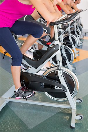 simsearch:400-07725687,k - Spin class working out in a row at the gym Photographie de stock - Aubaine LD & Abonnement, Code: 400-07725924