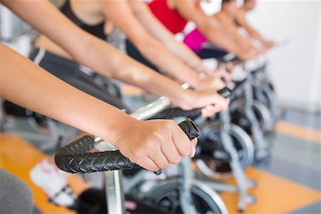 simsearch:400-07725687,k - Spin class working out in a row at the gym Photographie de stock - Aubaine LD & Abonnement, Code: 400-07725923