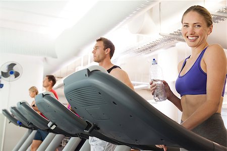 simsearch:400-07725687,k - Row of people working out on treadmills at the gym Photographie de stock - Aubaine LD & Abonnement, Code: 400-07725938