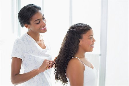 Pretty mother brushing her daughters hair at home in bathroom Stock Photo - Budget Royalty-Free & Subscription, Code: 400-07725961