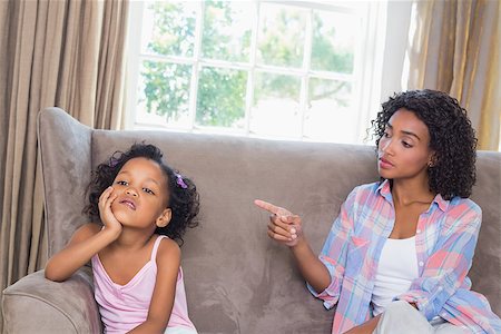 Pretty mother scolding her daughter on the couch at home in the living room Stock Photo - Budget Royalty-Free & Subscription, Code: 400-07726234