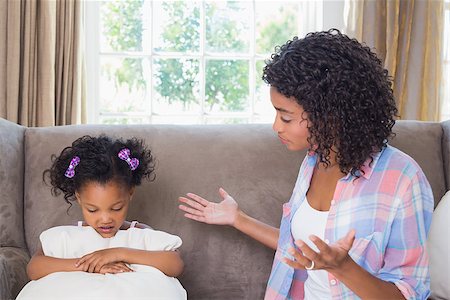 parent scolding kids - Pretty mother scolding her daughter on the couch at home in the living room Stock Photo - Budget Royalty-Free & Subscription, Code: 400-07726233