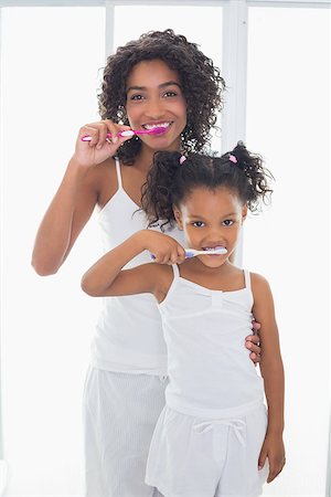 dental mother - Pretty mother with her daughter brushing their teeth at home in the bathroom Stock Photo - Budget Royalty-Free & Subscription, Code: 400-07726261