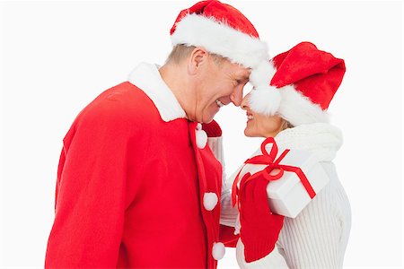 Festive older couple smiling at each other and holding gift on white background Stock Photo - Budget Royalty-Free & Subscription, Code: 400-07726375