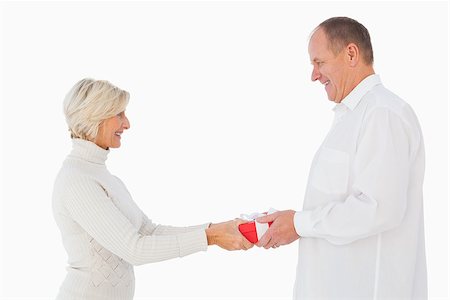 simsearch:400-07726694,k - Blonde woman passing gift to her partner on white background Foto de stock - Royalty-Free Super Valor e Assinatura, Número: 400-07726381