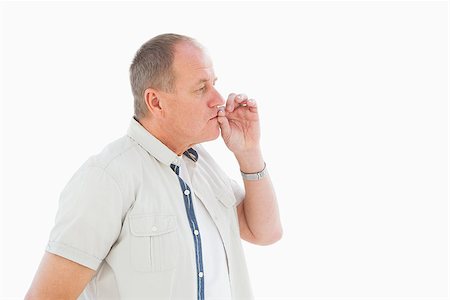 simsearch:400-07726578,k - Older man holding hand to mouth for silence on white background Fotografie stock - Microstock e Abbonamento, Codice: 400-07726442