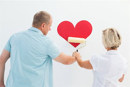 senior woman with paint roller - Happy older couple painting red heart on white background Stock Photo - Budget Royalty-Free & Subscription, Code: 400-07726455