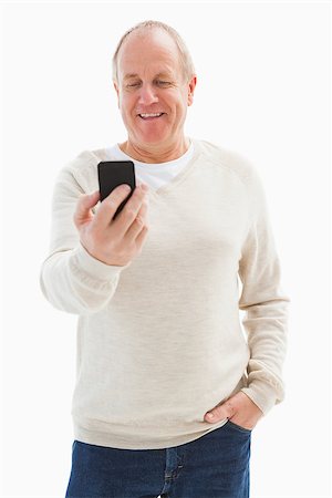 Happy mature man sending a text on white background Stock Photo - Budget Royalty-Free & Subscription, Code: 400-07726502