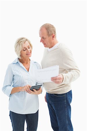 Mature couple working out their bills on white background Stock Photo - Budget Royalty-Free & Subscription, Code: 400-07726539