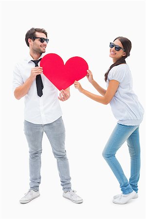 simsearch:400-07935196,k - Hipster couple smiling at camera holding a heart on white background Foto de stock - Royalty-Free Super Valor e Assinatura, Número: 400-07726705