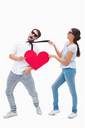 simsearch:400-07726694,k - Brunette pulling her boyfriend by the tie on white background Foto de stock - Super Valor sin royalties y Suscripción, Código: 400-07726706