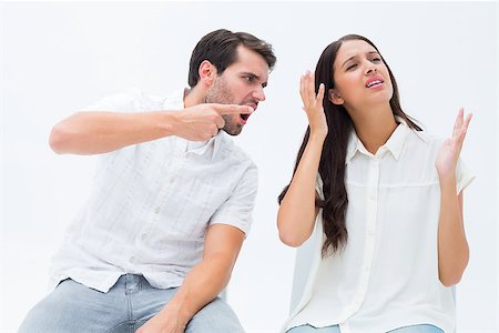 Couple sitting on chairs arguing on white background Stock Photo - Budget Royalty-Free & Subscription, Code: 400-07726744