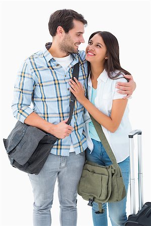 Attractive young couple going on their holidays on white background Stock Photo - Budget Royalty-Free & Subscription, Code: 400-07726776