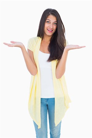 shoulder shrug - Happy casual woman shrugging her shoulders on white background Stock Photo - Budget Royalty-Free & Subscription, Code: 400-07726859