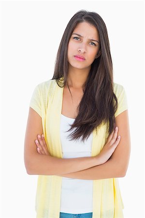 simsearch:400-07778671,k - Frowning casual woman looking at camera on white background Fotografie stock - Microstock e Abbonamento, Codice: 400-07726863