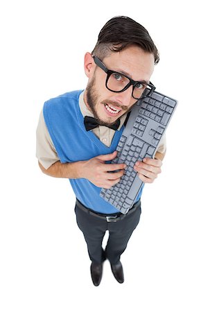 simsearch:400-07778671,k - Geeky hipster looking at camera holding keyboard on white background Fotografie stock - Microstock e Abbonamento, Codice: 400-07727028