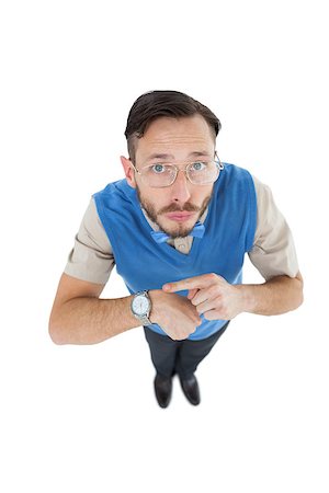 simsearch:400-07778671,k - Geeky hipster looking at camera pointing at watch on white background Fotografie stock - Microstock e Abbonamento, Codice: 400-07727029