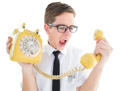 frustration vintage - Geeky businessman shouting at retro phone on white background Foto de stock - Super Valor sin royalties y Suscripción, Código: 400-07727103