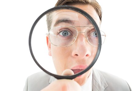 Geeky businessman looking through magnifying glass on white background Stock Photo - Budget Royalty-Free & Subscription, Code: 400-07727126