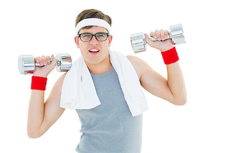 Geeky hipster lifting heavy dumbbells on white background Stock Photo - Budget Royalty-Free & Subscription, Code: 400-07727289