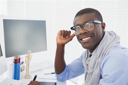 designer (graphic, male) - Hipster businessman smiling at camera at his desk in his office Stock Photo - Budget Royalty-Free & Subscription, Code: 400-07727342