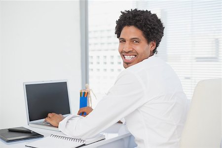 simsearch:400-07926810,k - Happy businessman working at his desk in his office Fotografie stock - Microstock e Abbonamento, Codice: 400-07727436