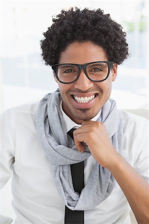 simsearch:400-07926810,k - Hipster businessman smiling at camera in his office Fotografie stock - Microstock e Abbonamento, Codice: 400-07727457