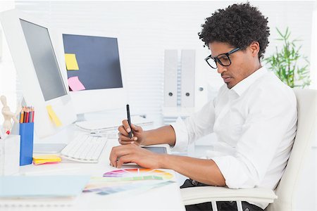 simsearch:400-07926810,k - Hipster designer working at his desk in his office Fotografie stock - Microstock e Abbonamento, Codice: 400-07727464